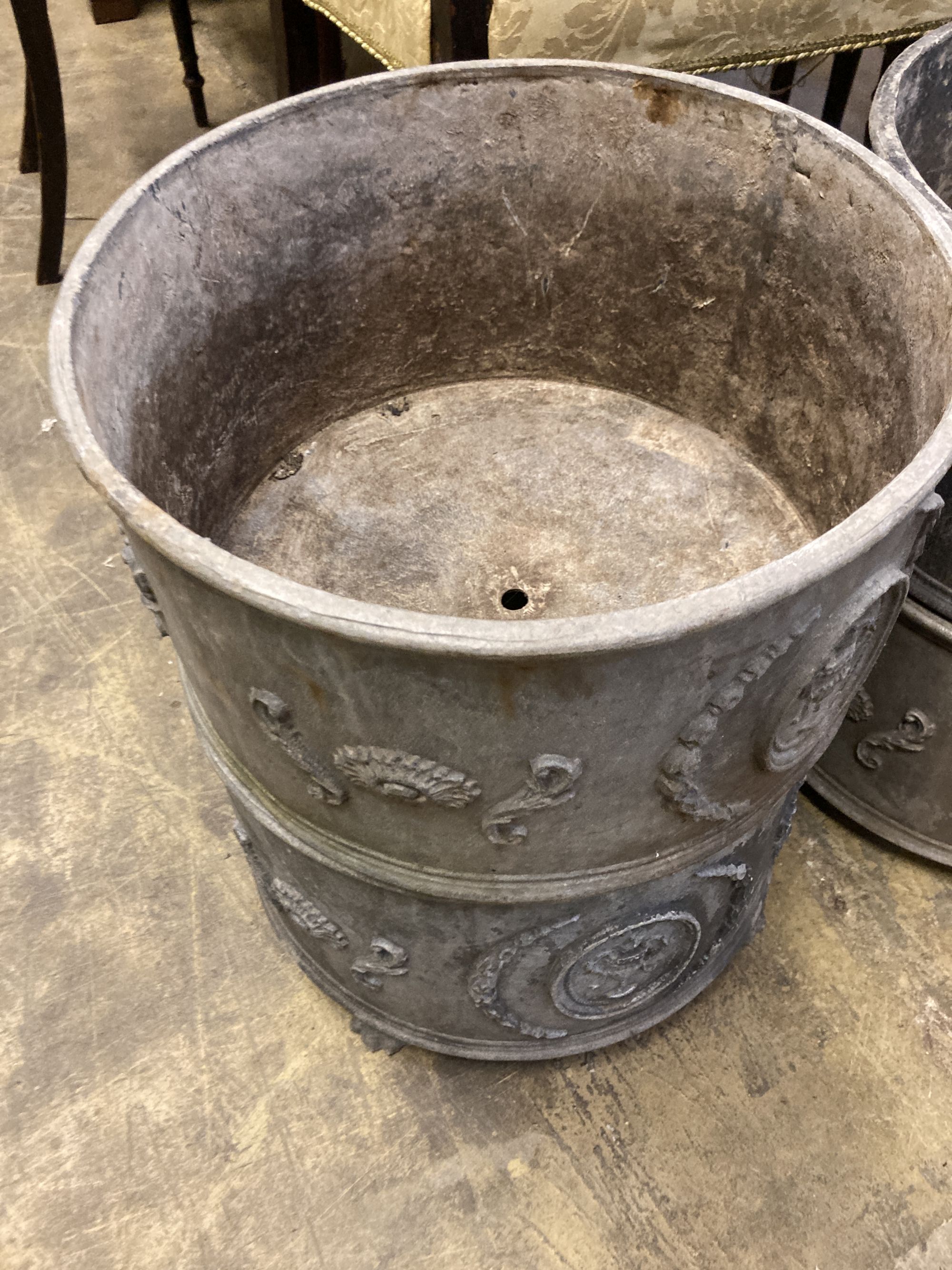 A set of four circular lead garden planters, 37cm diameter, height 20cm